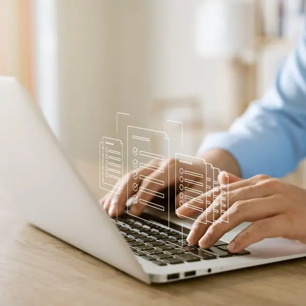 Person working on laptop with digital documents overlay